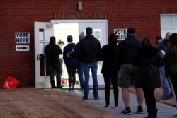 FILE - Voters line up early in the morning to cast their ballots in the U.S. Senate runoff election, at a polling station in Marietta, Georgia, Jan. 5, 2021.