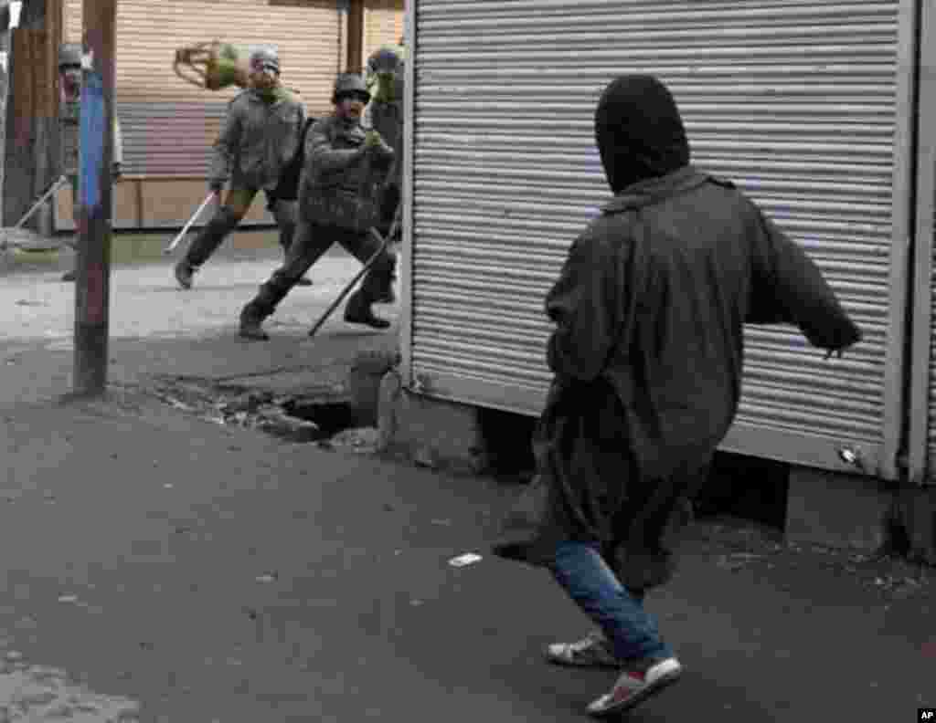 A Kashmiri protester throws a "kangri" or Kashmiri traditional firepot towards Indian police during a protest in Srinagar January 21, 2012. The protest was organised by separatist group, Jammu Kashmir Liberation Front (JKLF), to mark the anniversary of th