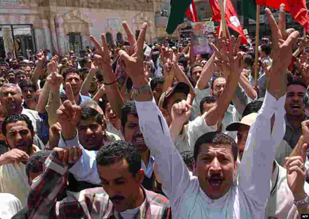 Jordanian and Palestinian protesters flash victory signs as they shout slogans against Israel and the US during a sit-in in front of al-Husseini Mosque in downtown Amman, Jordan, Friday May 21, 2004. Around 1,000 worshippers representing opposition parti