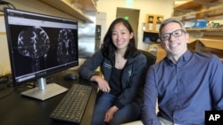 This undated photo provided by the Oregon Health & Science University in October 2024 shows Drs. Erin Yamamoto (L) and Juan Piantino, who used special imaging to spot a long-suspected pathway the human brain uses to clear waste. (Christine Torres Hicks/OHSU via AP)