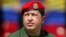 FILE - Venezuelan President Hugo Chavez wears an army uniform and the red beret of his parachute regiment while he attends a military parade in Caracas, April 13, 2005.