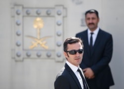 Plain-clothes security officers guard the entrance to Saudi Arabia's consulate in Istanbul, prior to a ceremony outside, marking the one-year anniversary of the killing of Saudi journalist Jamal Khashoggi, Oct. 2, 2019.