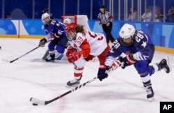 FILE - Amanda Kessel (28), of the United States, drives the puck against Russia's Yelena Dergachyova (59) during the third period of a women's hockey game at the 2018 Winter Olympics in Gangneung, South Korea, Feb. 13, 2018