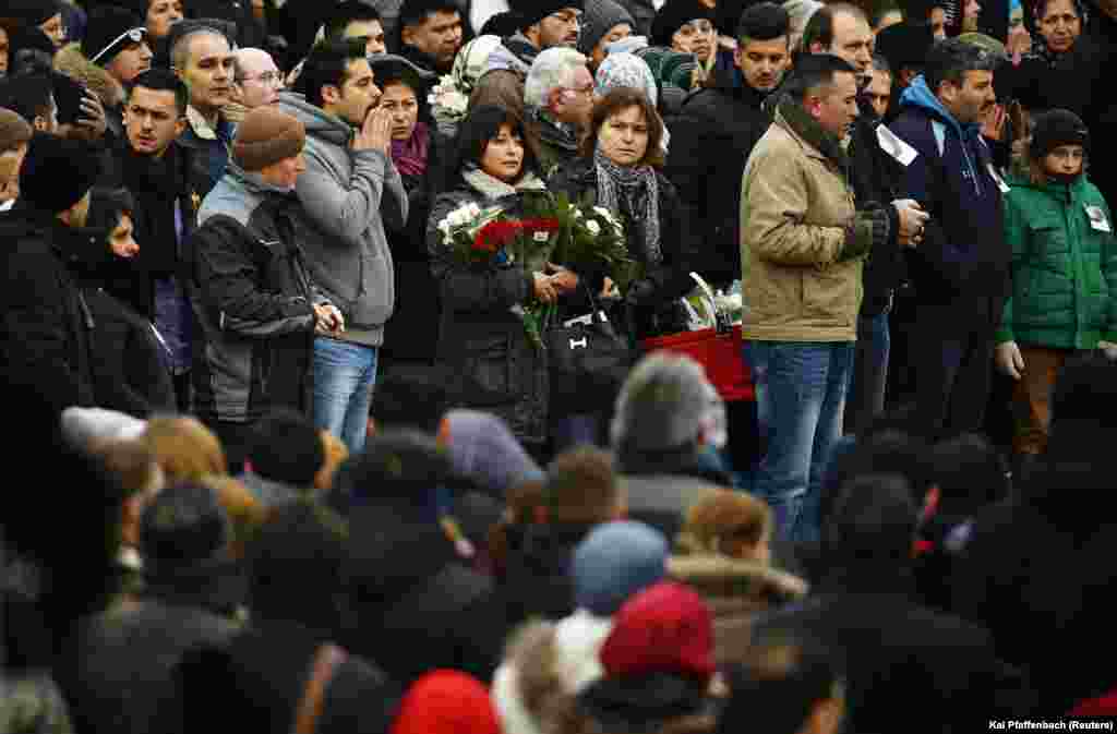 Mourners pray outside a mosque during a memorial service for late student Tugce Albayrak in Waechtersbach, Dec. 3, 2014