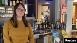 FILE - Gina Cimarosti, manager of the London Tavern Hotel, stands in her empty pub in Melbourne, which is in lockdown due to the coronavirus disease (COVID-19), Australia, Oct. 21, 2020.