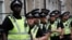 FILE - Police officers stand by during a protest against the visit of U.S. President Donald Trump, in central London, Britain, July 13, 2018. 