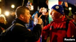 Pro-Brexit and anti-Brexit demonstrators shout at each other opposite the Houses of Parliament, in Westminster, central London, Britain, Dec. 11, 2018.