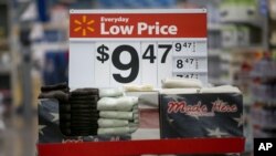 FILE - Towels are on display on a sale rack at a Walmart store in Rogers, Arkansas.