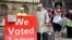 Pro Brexit demonstrators hold a placard outside the Houses of Parliament, in London, Sept. 5, 2019.