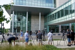 TV cameras set up outside the Lake County courthouse for the extradition hearing for Kyle Rittenhouse, Aug. 28, 2020, in Waukegan, Ill. Prosecutors have charged the 17-year-old from Illinois in the fatal shooting of two protesters in Kenosha.