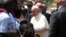 Pope Francis greets internally displaced people sheltering on the grounds of the Saint Sauveur church, during his visit in the capital Bangui, Central African Republic, Nov. 29, 2015.