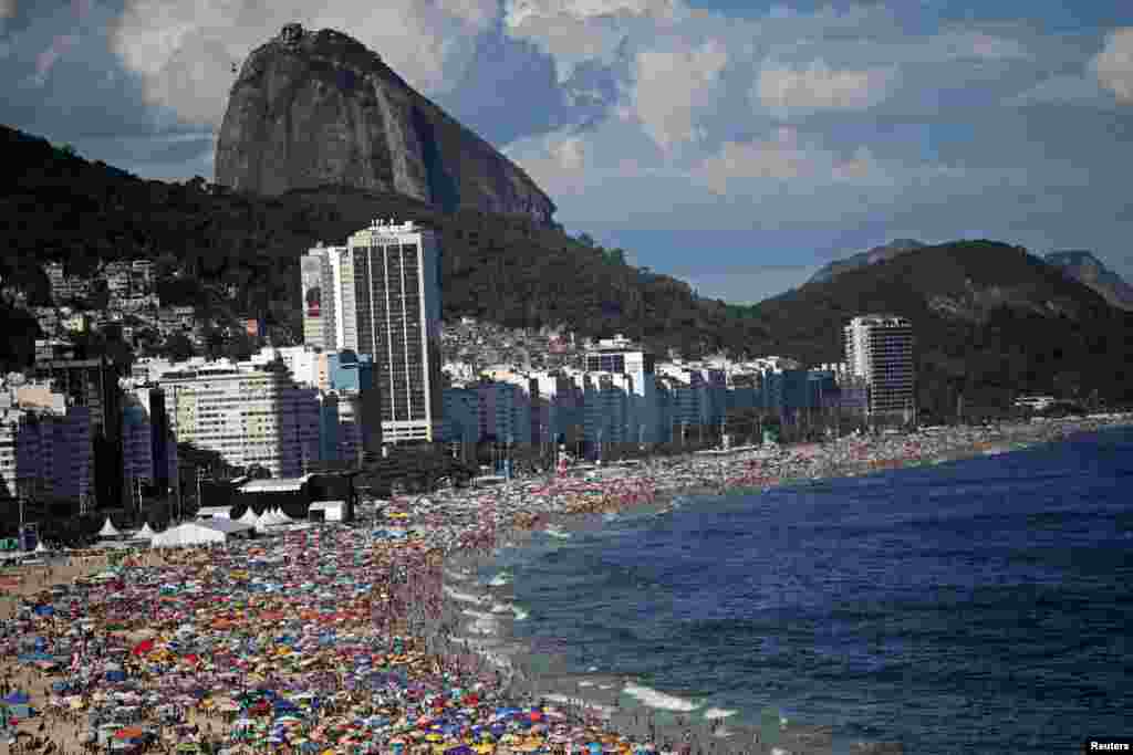 Residents and tourists enjoy the sun at Copacabana beach before New Year celebrations in Rio de Janeiro, Brazil.
