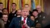 FILE - President Donald Trump holds a statue of the Wounded Warrior Project logo as he speaks at a Wounded Warrior Project Soldier Ride event in the East Room of the White House, in Washington, April 18, 2019.