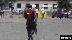 A supporter of Egypt's President Mohamed Morsi holds sticks after night clashes with anti-Morsi around Cairo University and Nahdet Misr Square in Giza, on the outskirts of Cairo, July 3, 2013. 