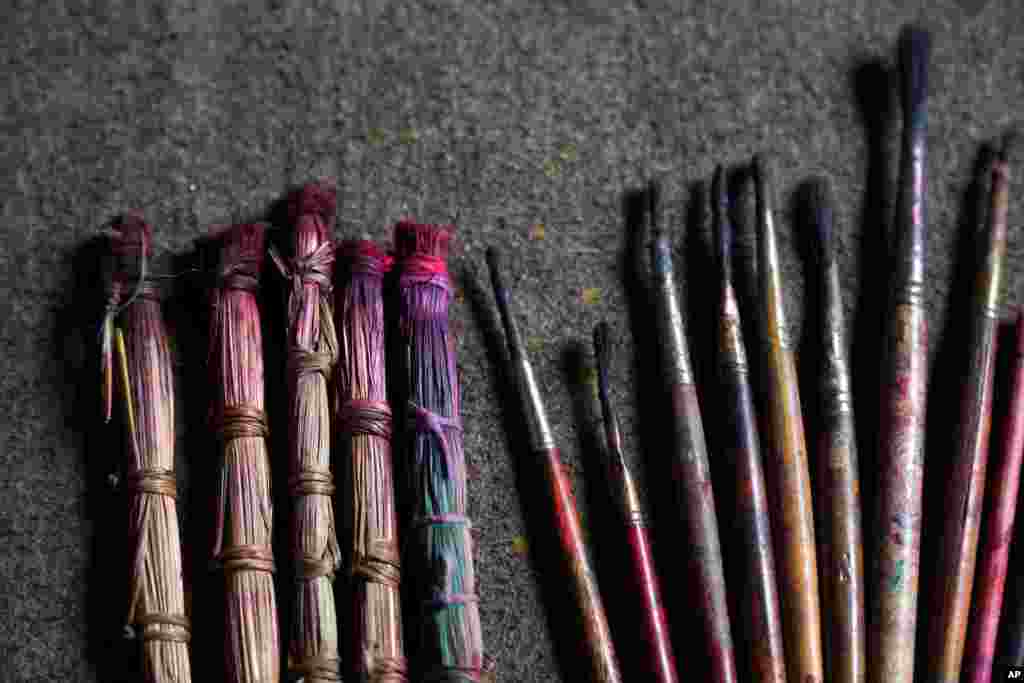 Handmade traditional brushes, left, are lined up along with modern paint brushes at the residence of Chitrakar couple Tej Kumari and Purna, in Bhaktapur, Nepal, July 31, 2019.