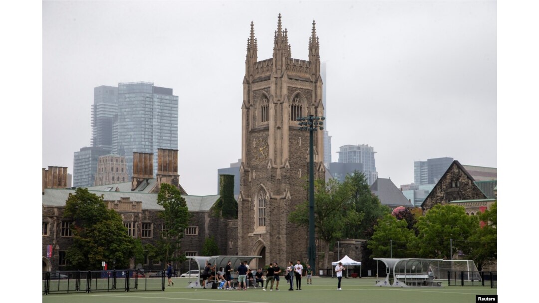 FILE - People take a break from playing sports on the grounds of the University of Toronto, Sept. 9, 2020.