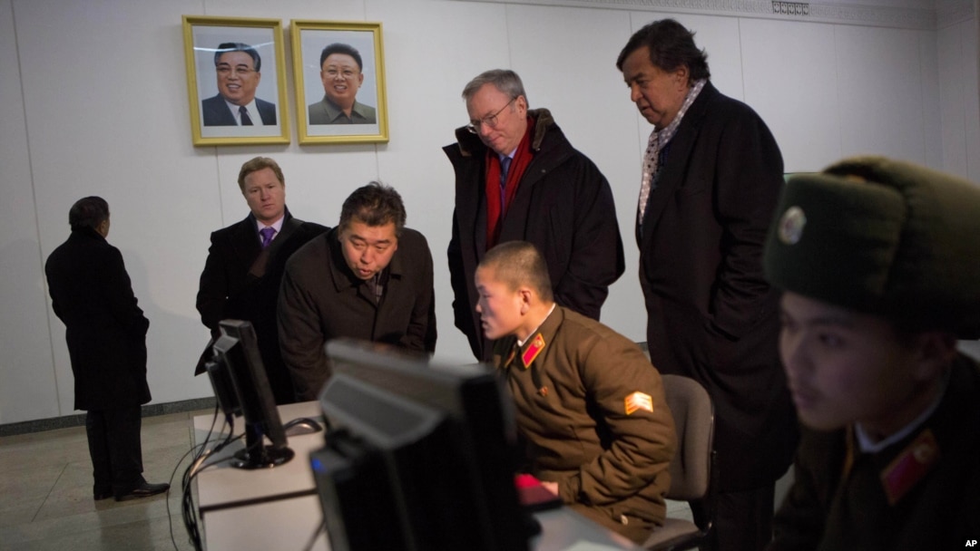 Executive Chairman of Google Eric Schmidt and former governor of New Mexico Bill Richardson look at soldiers working on computers at the Grand Peoples Study House, Pyongyang, North Korea, January 9, 2013.