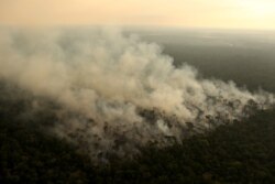 Smoke billows during a fire in an area of the Amazon rainforest near Porto Velho, Rondonia State, Brazil, Sept. 10, 2019.