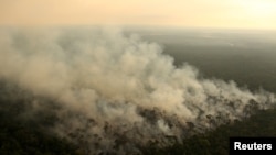 Smoke billows during a fire in an area of the Amazon rainforest near Porto Velho, Rondonia State, Brazil, Sept. 10, 2019.