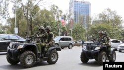 Kenyan police patrol along a main street as the country prepares to receive U.S. President Barack Obama for his three-day state visit, in Kenya's capital Nairobi, July 24, 2015. 