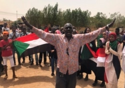 FILE - A Sudanese protester shouts slogans during a demonstration against the military council, in Khartoum, Sudan, June 30, 2019.