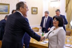 In this photo released by Russian Foreign Ministry Press Service, Russian Foreign Minister Sergey Lavrov, left, greets Sahiba Gafarova Chairman of the National Assembly of Azerbaijan during their meeting in Moscow, Russia, Sept. 23, 2020.