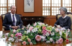 FILE - South Korean Foreign Minister Kang Kyung-wha talks with David Stilwell, U.S. Assistant Secretary of State for the Bureau of East Asian and Pacific Affairs, during a meeting at the foreign ministry in Seoul, July 17, 2019.