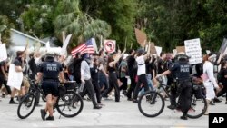 Orlando Police block a street to allow demonstrators to march by during a protest over the death of George Floyd, June 2, 2020, in Orlando, Florida.