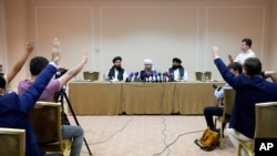 Members of political delegation from the Afghan Taliban's movement Dr, Mohammad Naim, left, Mawlawi Shahabuddin Dilawar, center, and Suhil Shaheen attend a news conference in Moscow, Russia, July 9, 2021. 