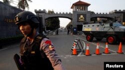 A mobile brigade policeman stands in front of the Mobile Police Brigade (Brimob) headquarters in Depok, south of Jakarta, Indonesia, May 9, 2018. 