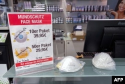 A sign advertising protective face masks is marked "Sold out" inside a store in Berlin, Germany, Feb. 28, 2020.