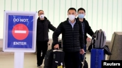 FILE - Passengers arrive at LAX airport from Shanghai, China, before restrictions were put in place to halt the spread of the coronavirus, in Los Angeles, California, Jan. 26, 2020.