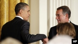 U.S. President Barack Obama greets House Speaker John Boehner before delivering remarks at a dinner of bipartisan committee chairmen and ranking members and their spouses at the White House, May 2, 2011