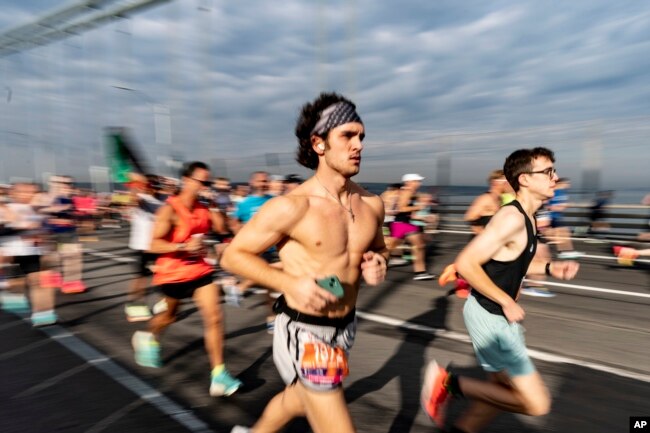 FILE - Runners cross the Verrazzano-Narrows Bridge at the start of the New York City Marathon, in New York, Sunday, Nov. 5, 2023. (AP Photo/Peter K. Afriyie)