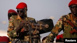 SPLA soldiers stand in a vehicle in Juba December 20, 2013. Talks between South Sudan's President Salva Kiir and African mediators trying to broker a peace deal after six days of clashes between rival army factions are progressing well, Ethiopia's foreign