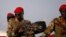 SPLA soldiers stand in a vehicle in Juba December 20, 2013. Talks between South Sudan's President Salva Kiir and African mediators trying to broker a peace deal after six days of clashes between rival army factions are progressing well, Ethiopia's foreign