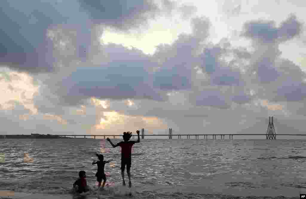 Children play in the Arabian Sea in Mumbai, India.