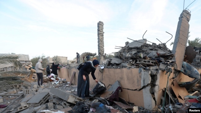 Palestinians inspect the site of an Israeli strike on a house, amid the ongoing conflict between Israel and Hamas, in Deir Al-Balah in the central Gaza Strip, Jan. 15, 2025.