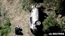 The vehicle of golfer Tiger Woods, who was rushed to a hospital after suffering multiple injuries, lies on its side after a single-vehicle accident in Los Angeles, California, in a still image from video taken Feb. 23, 2021. (KNBC via Reuters)