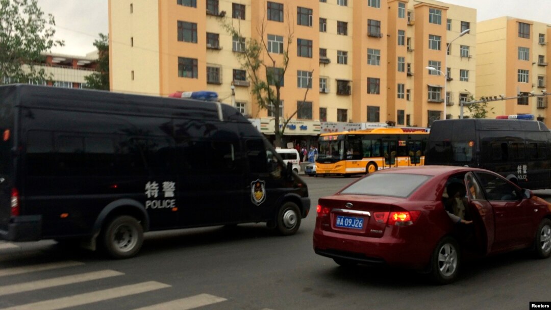 Police vehicles of the Special Weapons and Tactics (SWAT) team are seen after a blast occurred, on a road in Urumqi, Xinjiang Uighur Autonomous Region, May 22, 2014.