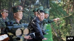 This Oct. 2, 2024, photo from North Korea's official Korean Central News Agency via KNS on Oct. 4, 2024, shows North Korea's leader Kim Jong Un, center, inspecting a training base of the Korean People's Army at an undisclosed location.