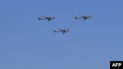 FILE - Russian Tupolev Tu-95 turboprop-powered strategic bombers are seen flying over the Kremlin in Moscow on May 7, 2019, during a rehearsal for the Victory Day military parade. 