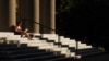 FILE - A student uses her laptop computer on the steps to Memorial Church at Harvard University in Cambridge, Massachusetts, Sept. 21, 2009. 