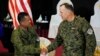 US Marine Corp MGEN Eric Austin, US Exercise Director Representative, right, and Philippine Army MGEN Marvin Licudin, Philippine Exercise Director shake hands at the opening ceremonies of a joint military exercise called "Balikatan," April 11, 2023, in Quezon City, Philippines. 