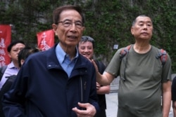 FILE - Hong Kong politician Martin Lee and founder of Next Media Jimmy Lai march during a protest to demand authorities scrap a proposed extradition bill with China, in Hong Kong, March 31, 2019.