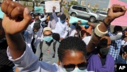Medical workers protest the death of a doctor who died of COVID-19, at a demonstration to honor medical staff who have died from the coronavirus and to demand better working conditions, in Nairobi, Kenya, Dec. 9, 2020. 