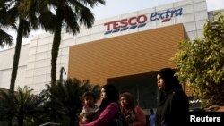 FILE - Shoppers are seen outside a Tesco Extra store in Kuala Lumpur, Malaysia, July 6, 2015.