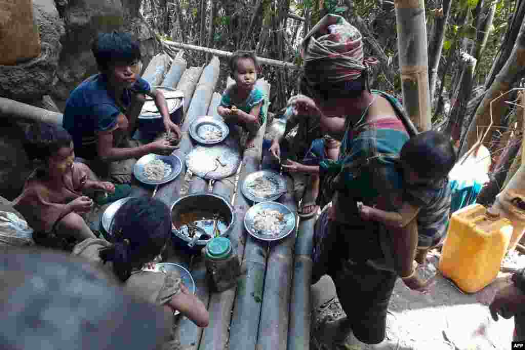 Karen villagers eat in the KNU Brigade 5 region in Myanmar&#39;s Karen state, after airstrikes by Myanmar military in the area following the February military coup. (Credit: KNU Doo Pla Ya District)
