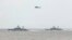 FILE - A Taiwan Navy helicopter flies over two Taiwan made corvettes during a navy exercise in the bound of Suao naval station in Yilan County, northeast of Taiwan, Apr. 13, 2018. 
