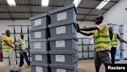 Election workers move boxes of voting materials at the National Electoral Commission headquarters in Monrovia, Oct. 9, 2017.